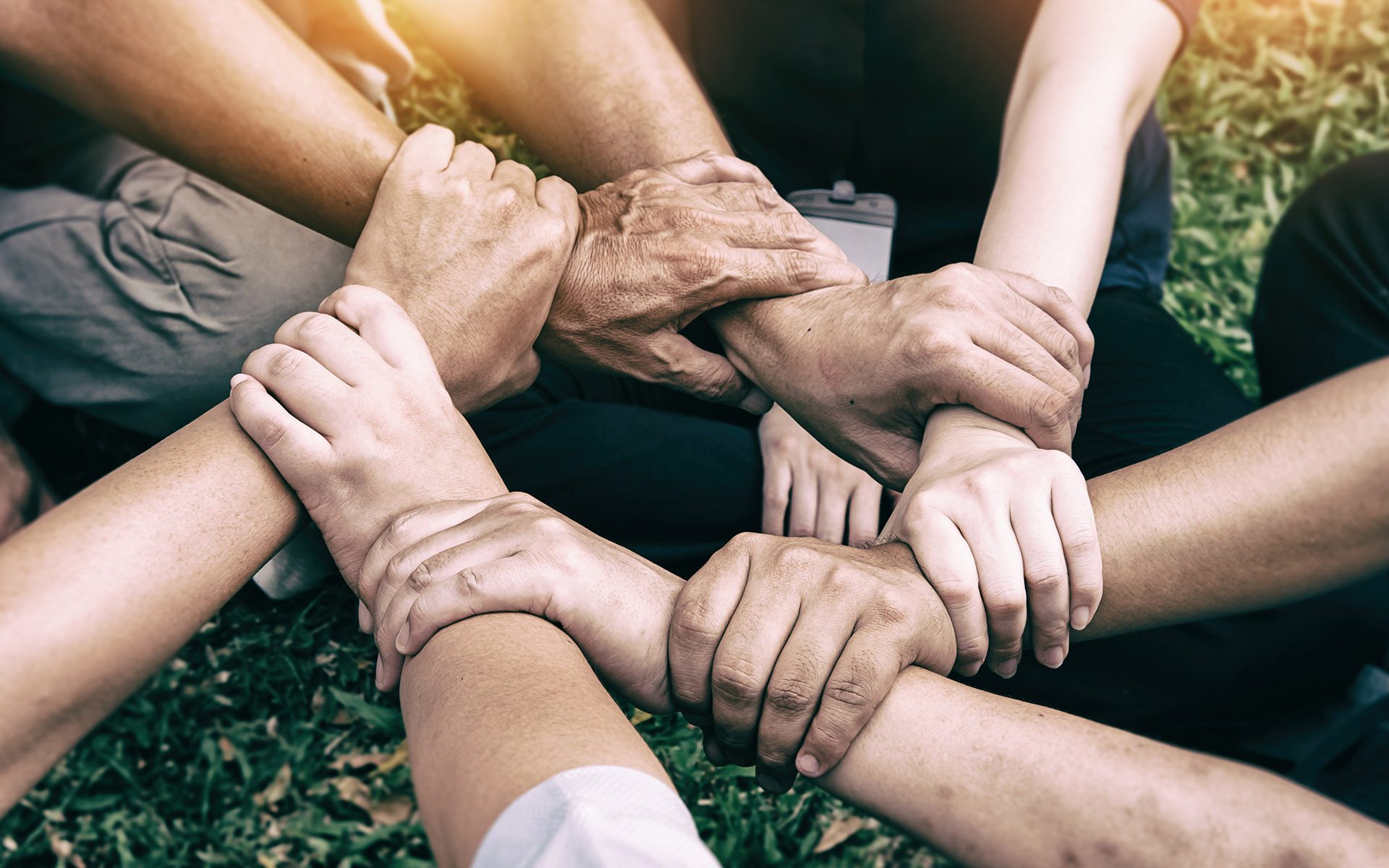 Homepage - Group of People Holding Each Other's Wrists